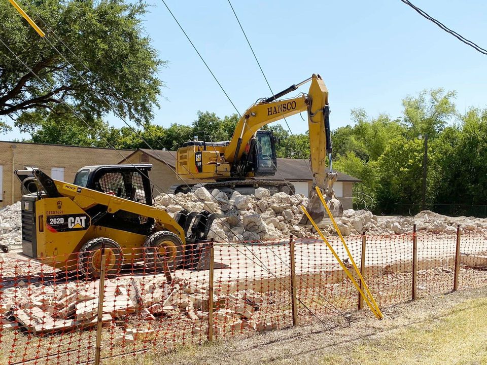 Hansco, Inc. excavator and skid steer clearing a demolition site